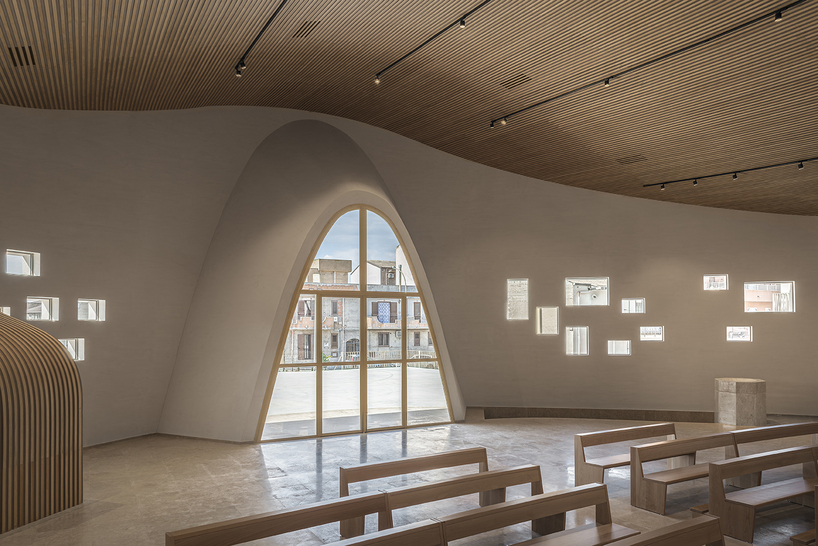 a flowing roof and fluid concrete walls frame the new santa barbara parish complex in sicily - 10