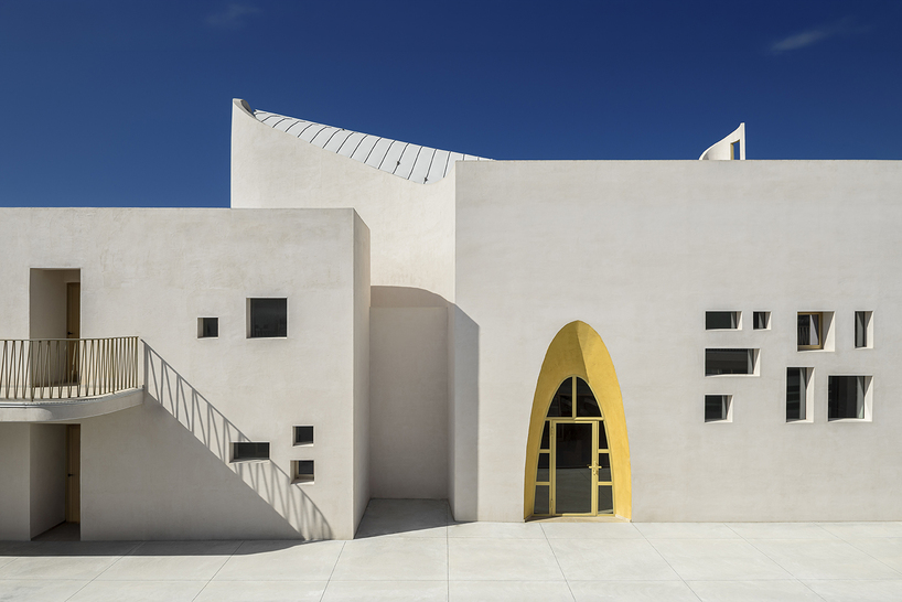 a flowing roof and fluid concrete walls frame the new santa barbara parish complex in sicily - 4