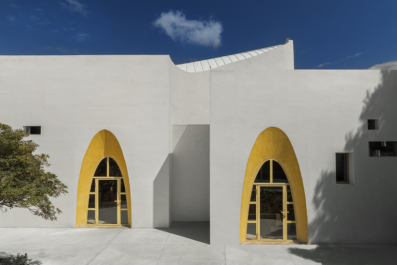 a flowing roof and fluid concrete walls frame the new santa barbara parish complex in sicily - 5