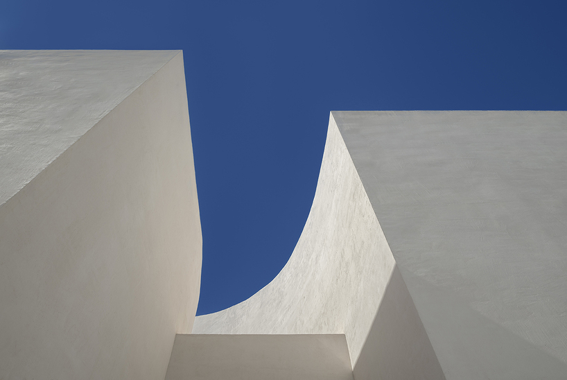a flowing roof and fluid concrete walls frame the new santa barbara parish complex in sicily - 7