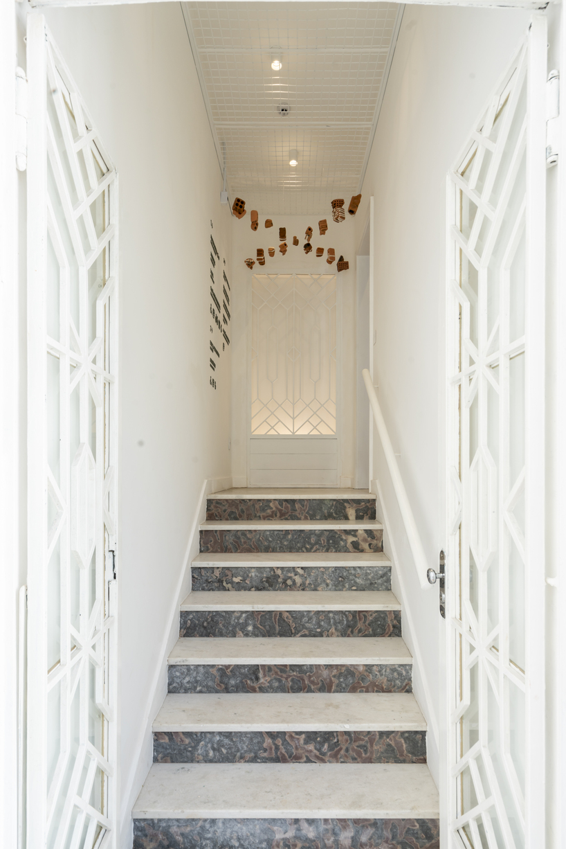 exposed brick and blue metal transform a 1930s brazilian house into a cultural art hub - 3