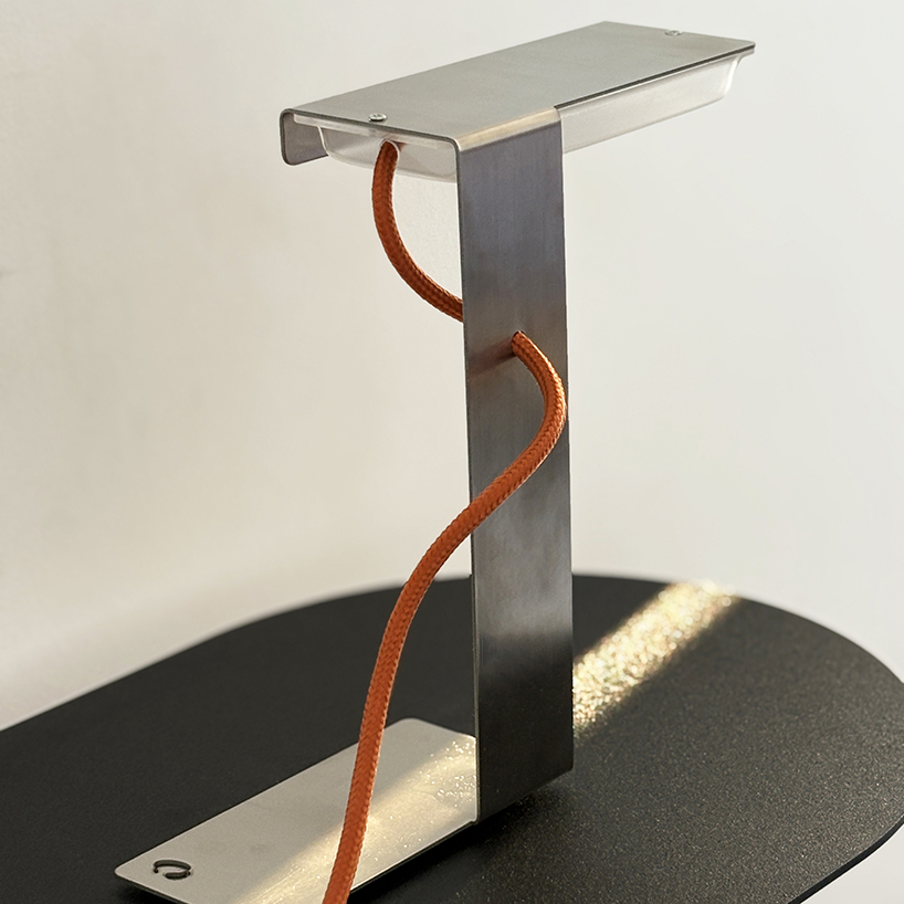 single sheet of folded steel sculpts into z-shaped table lamp - 6
