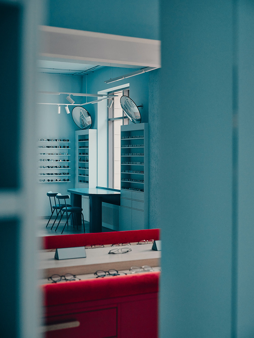 hubarch wraps an optics boutique in cold blue with single red interruption 11