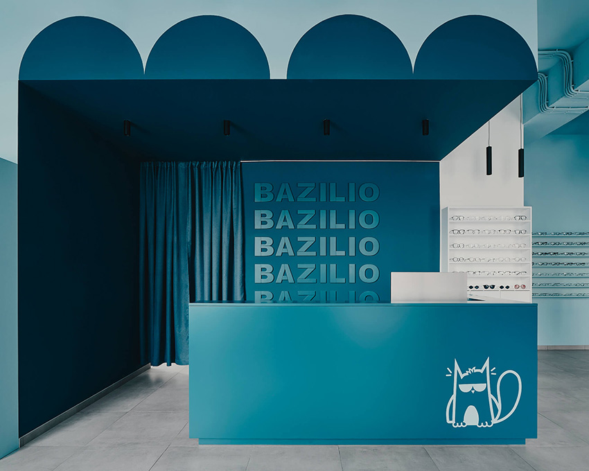 hubarch wraps an optics boutique in cold blue with single red interruption 7