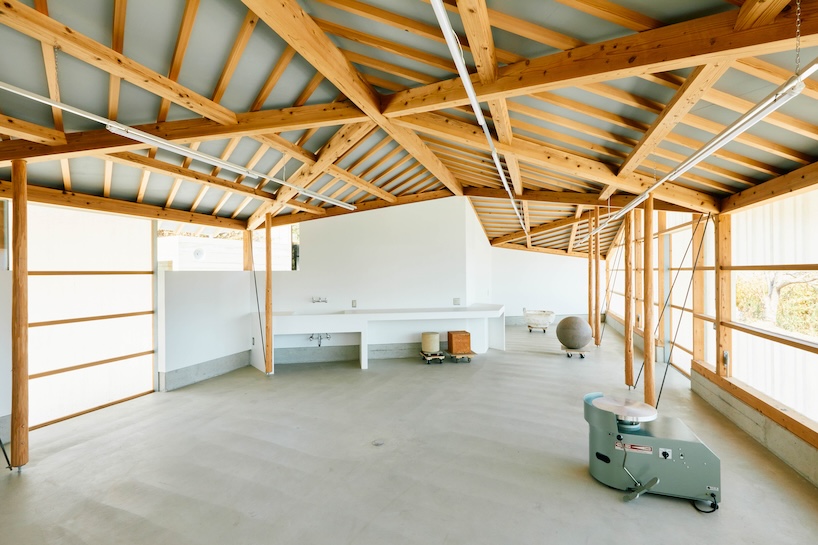 triangular timber structure encloses tsukumo kiln ceramic studio in kobe, japan - 7
