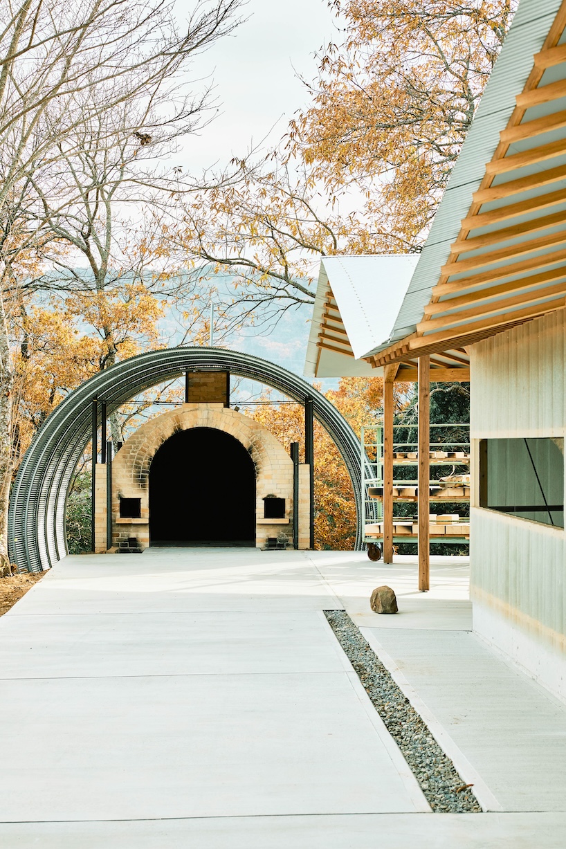triangular timber structure encloses tsukumo kiln ceramic studio in kobe, japan - 5