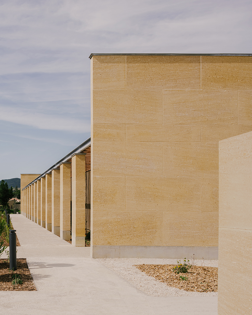 tectoniques designs a cultural center shaped by a mineral stone enclosure 5