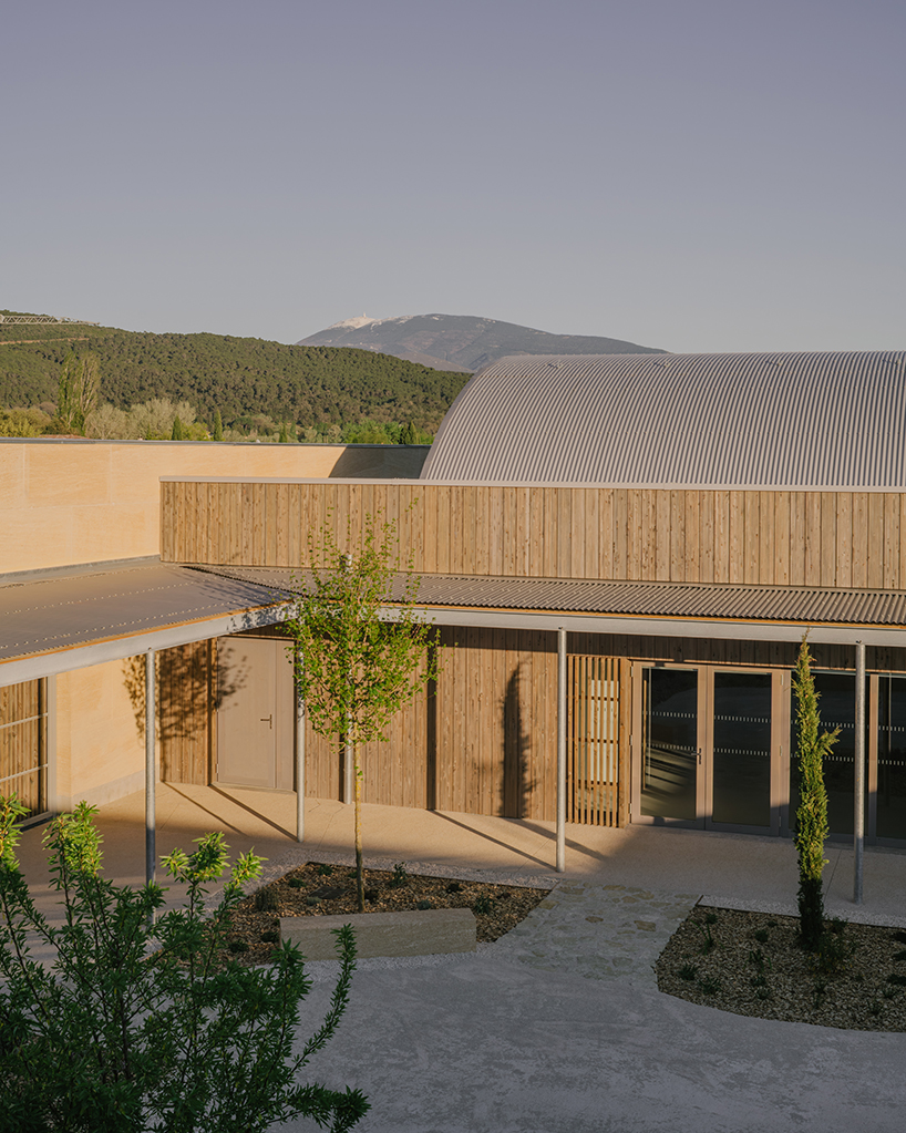 tectoniques designs a cultural center shaped by a mineral stone enclosure 6