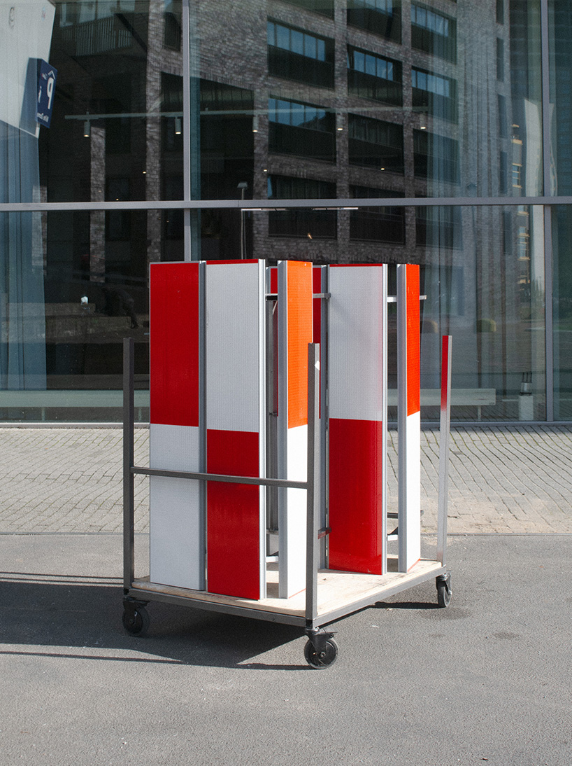 red-and-white aluminum safety barriers convert into public seating at dutch design week - 6