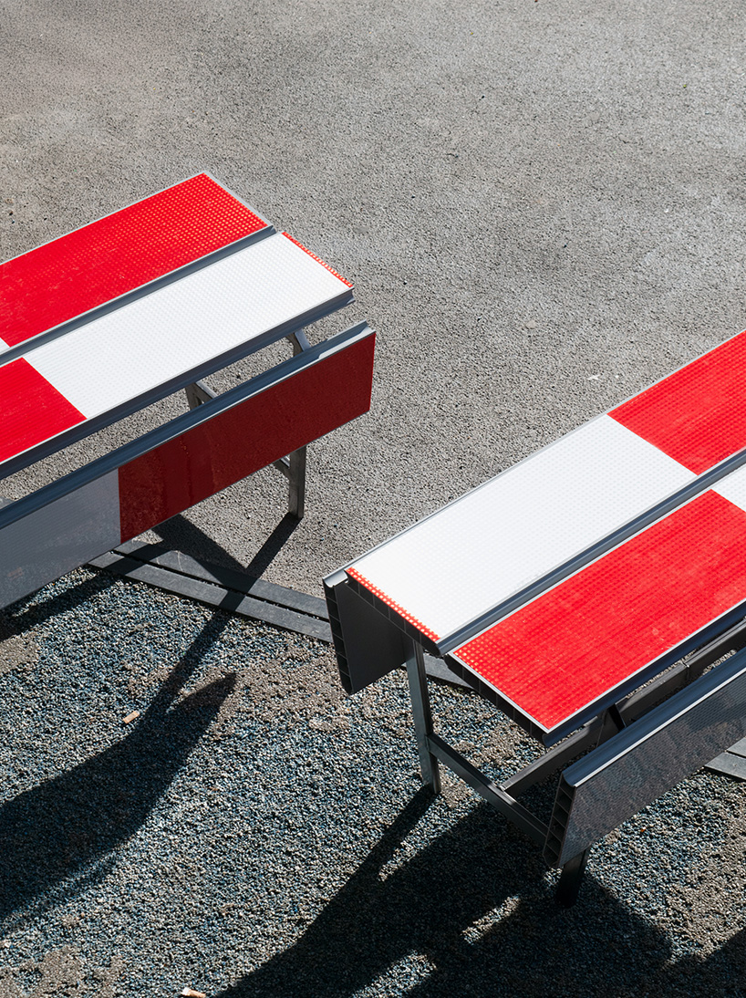 red-and-white aluminum safety barriers convert into public seating at dutch design week - 4