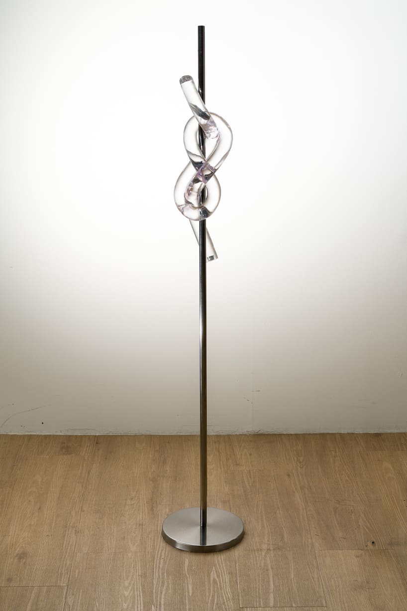 figure-eight knot casts into a glass light sculpture projecting shifting shadows - 3