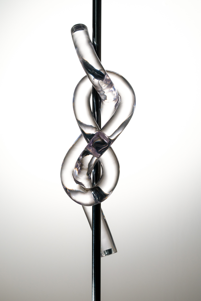figure-eight knot casts into a glass light sculpture projecting shifting shadows - 4