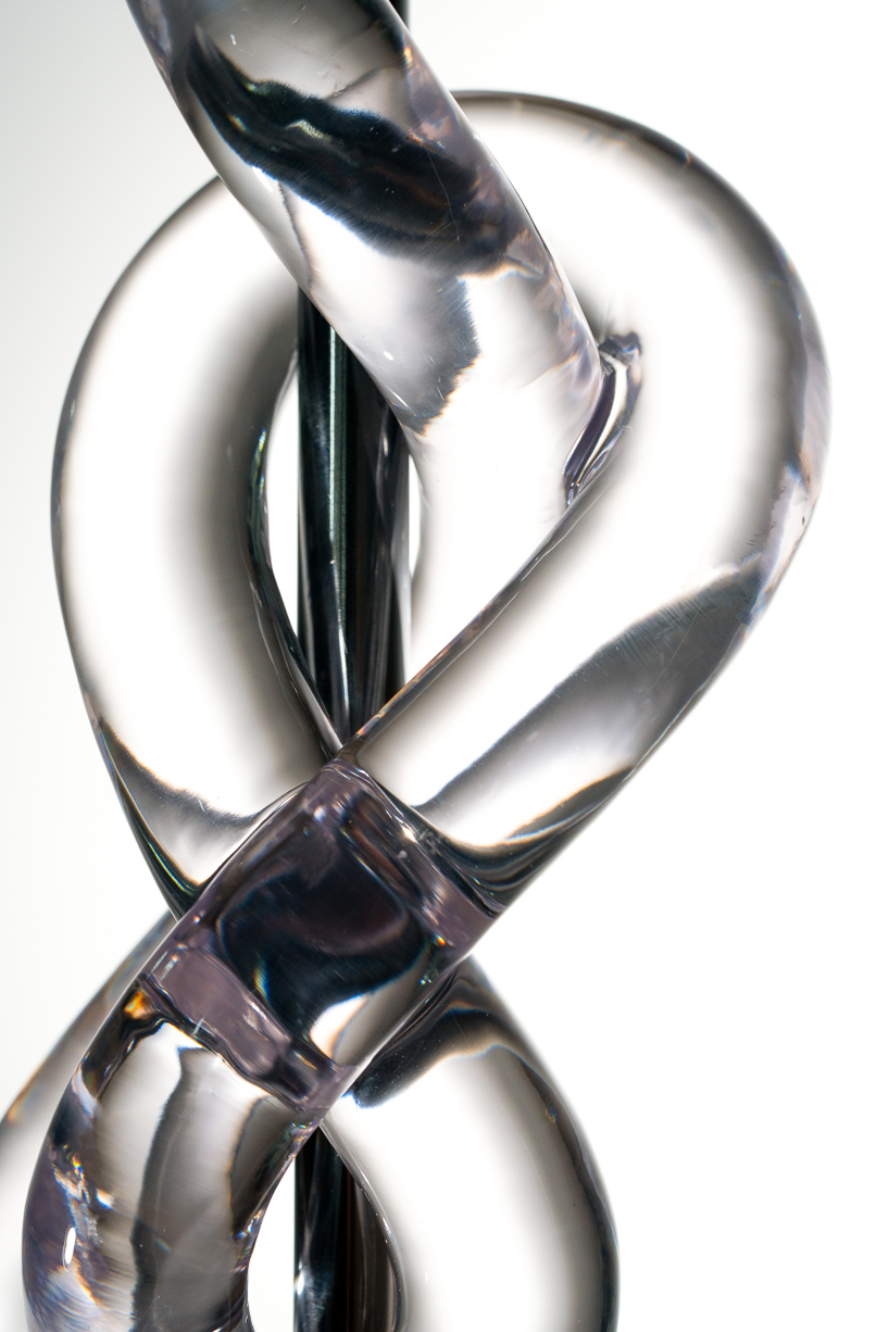 figure-eight knot casts into a glass light sculpture projecting shifting shadows - 5