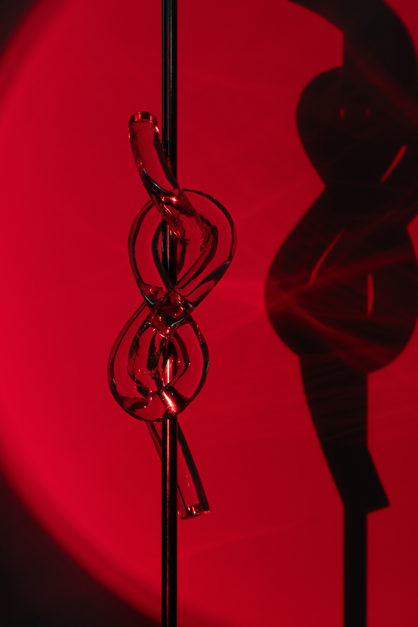 figure-eight knot casts into a glass light sculpture projecting shifting shadows - 6