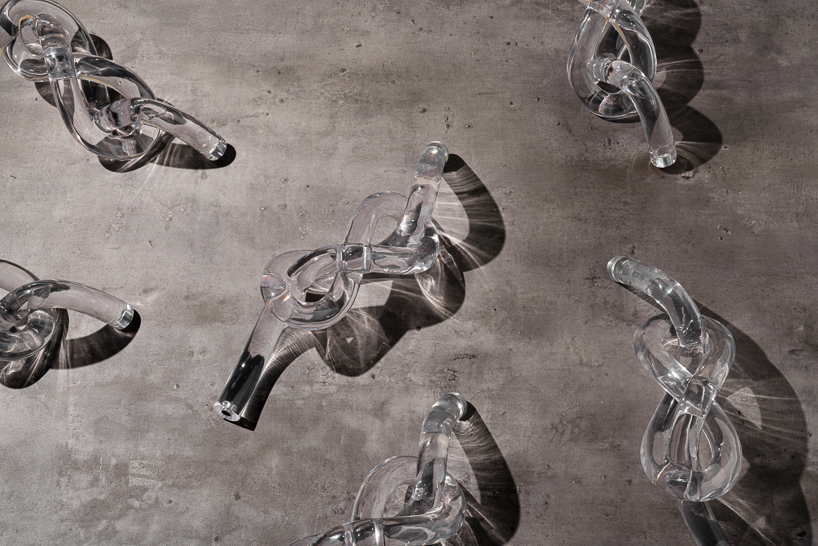 figure-eight knot casts into a glass light sculpture projecting shifting shadows - 1