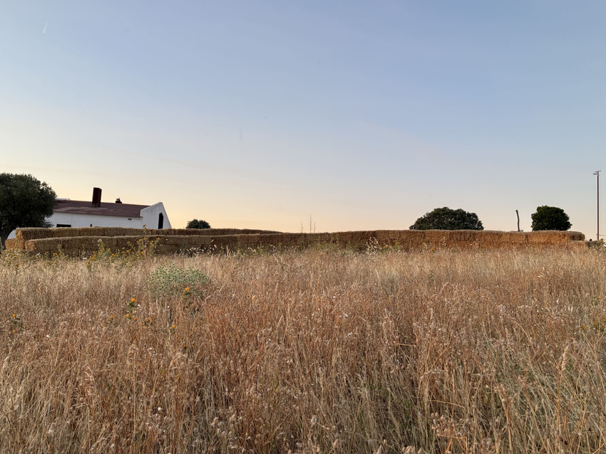 straw walls shape amphitheater, experimental garden and walking path in rural spain - 2