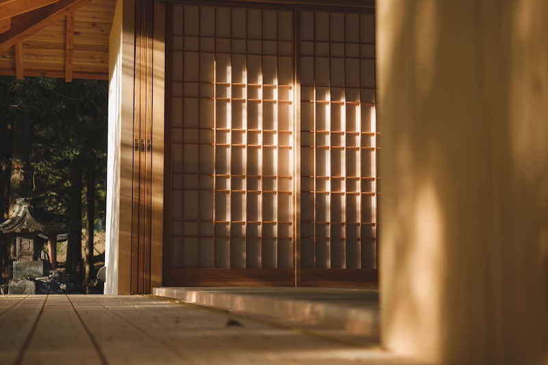 leaning timber frame anchors shrine office in japanese mountain valley - 7