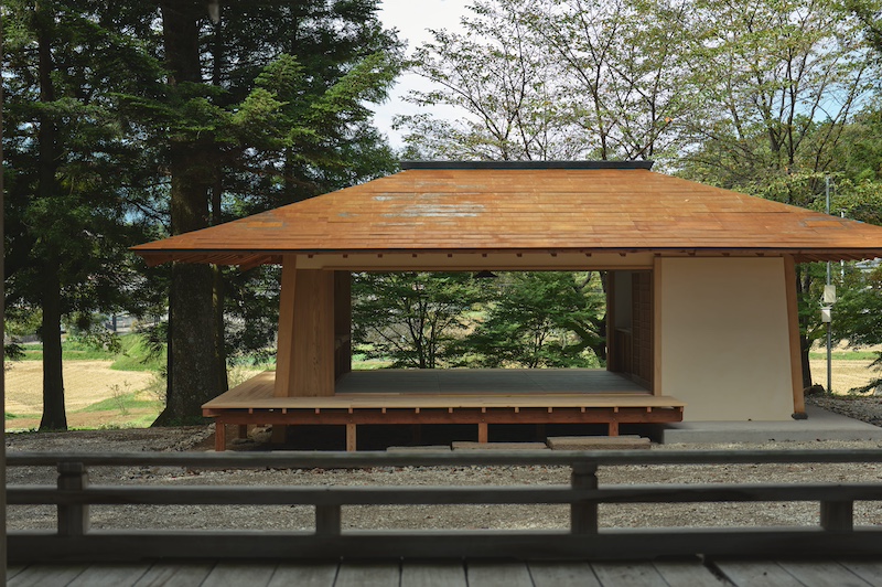 leaning timber frame anchors shrine office in japanese mountain valley - 2