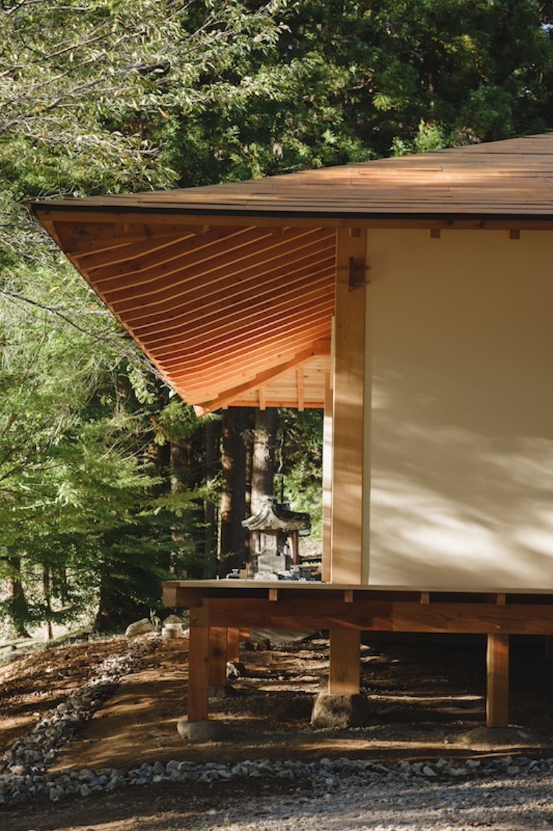leaning timber frame anchors shrine office in japanese mountain valley - 5