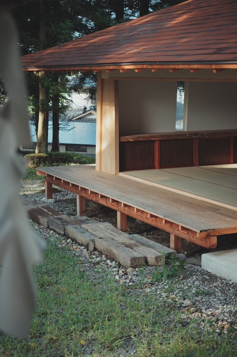 leaning timber frame anchors shrine office in japanese mountain valley - 6