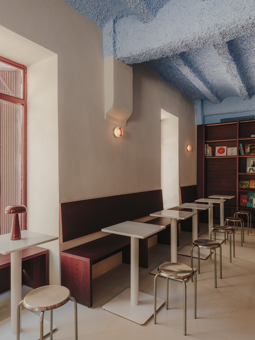 burgundy wood and blue ceilings shape café, bookshop, and wine bar in valencia - 9