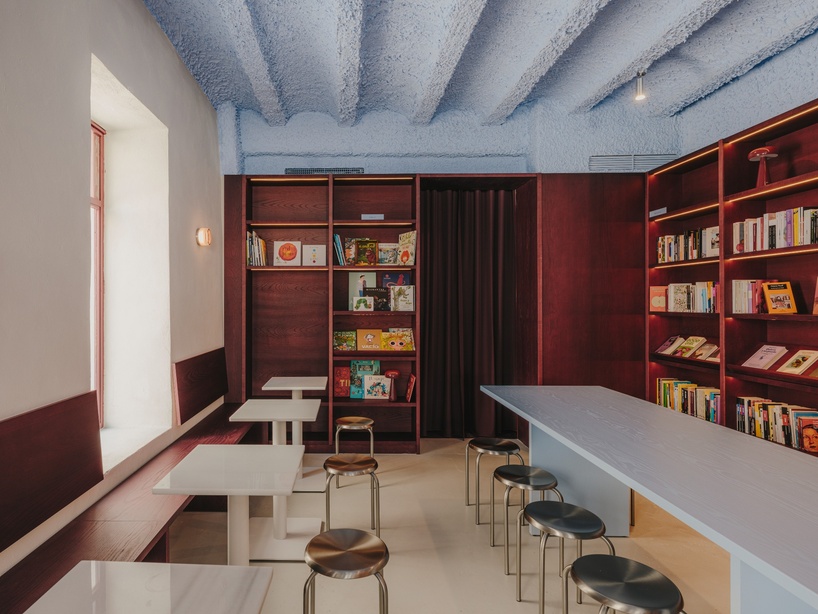 burgundy wood and blue ceilings shape café, bookshop, and wine bar in valencia - 2