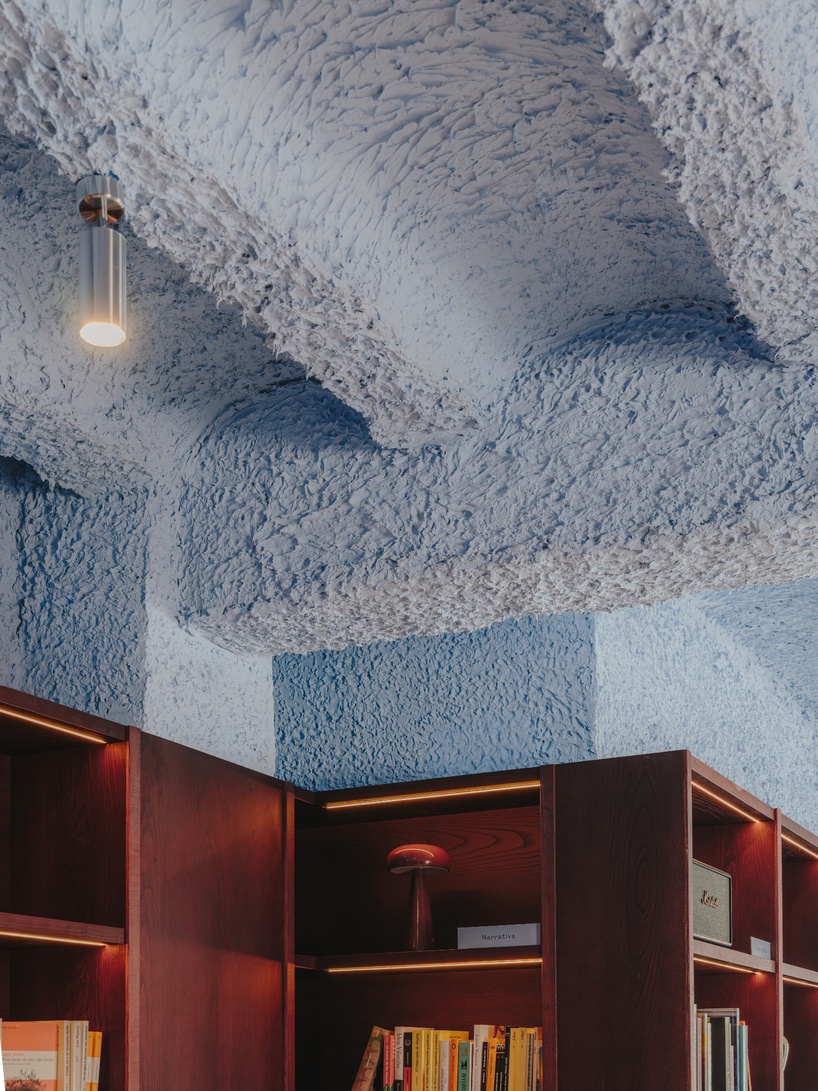 burgundy wood and blue ceilings shape café, bookshop, and wine bar in valencia - 5