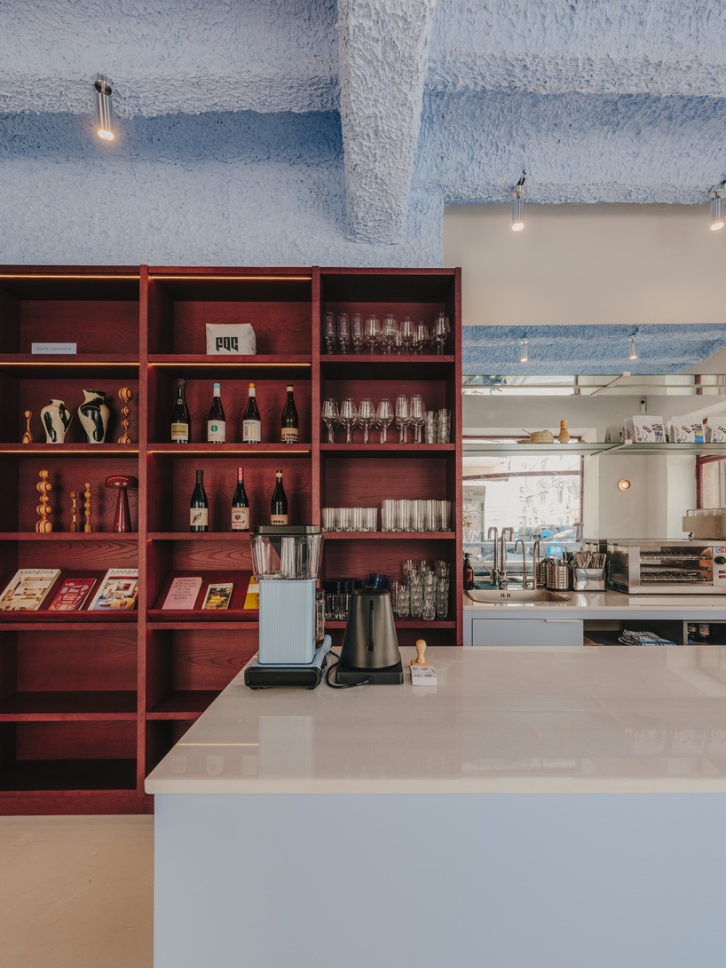 burgundy wood and blue ceilings shape café, bookshop, and wine bar in valencia - 6