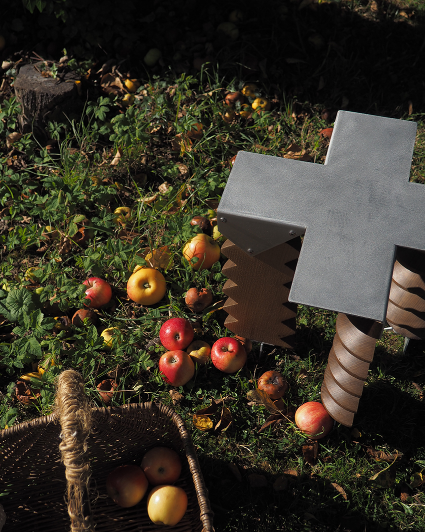brushed aluminum surface paired with aged wood in the LE PRESSOIR stool