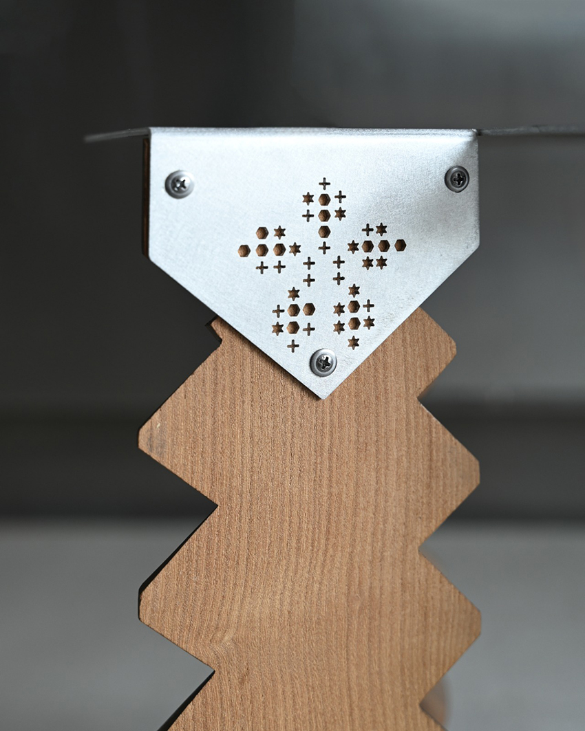 detail of the cross-shaped aluminum frame connecting the reclaimed timber elements