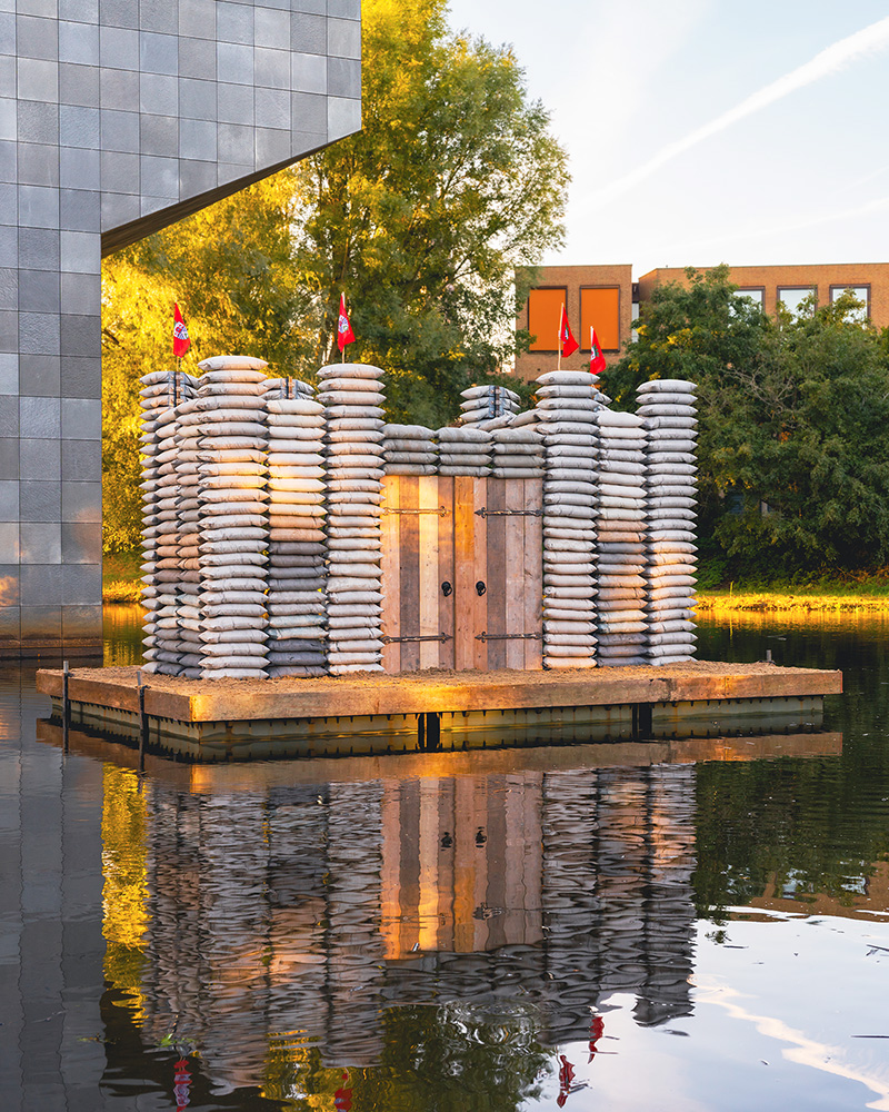 sandbag castle casts sustainable concrete alternatives into floating installation in eindhoven - 5