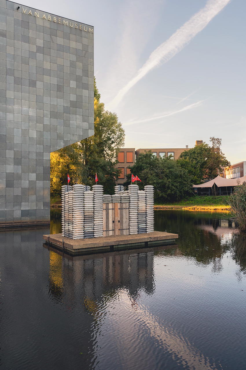 sandbag castle casts sustainable concrete alternatives into floating installation in eindhoven - 6