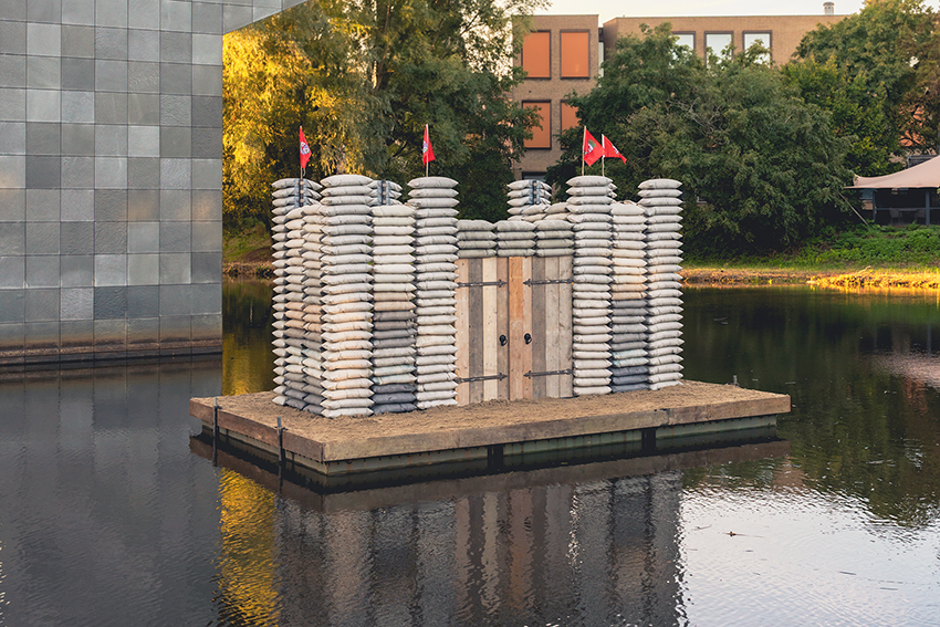 sandbag castle casts sustainable concrete alternatives into floating installation in eindhoven - 1