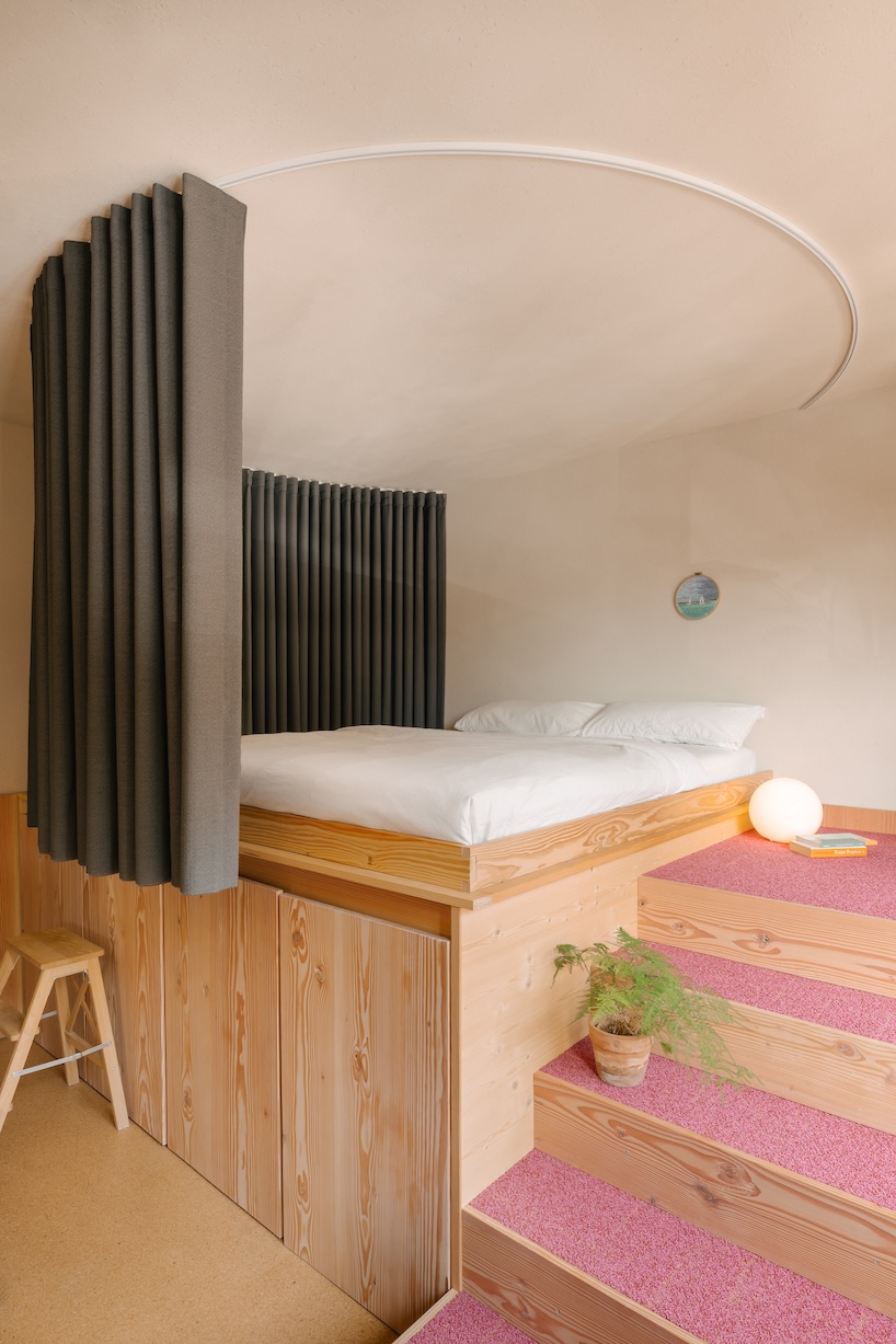 stepped timber platforms and operable textiles shape circular düsseldorf home by urselmann interior - 7