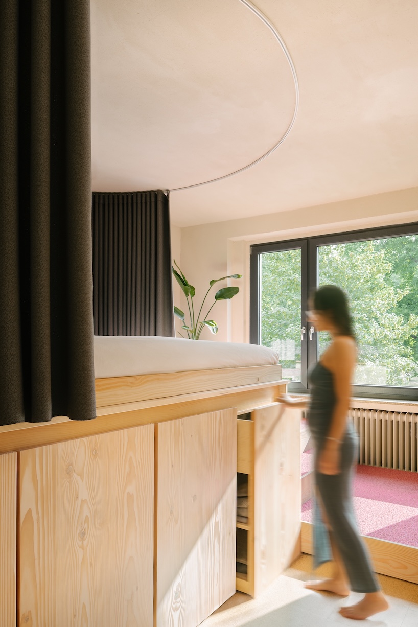 stepped timber platforms and operable textiles shape circular düsseldorf home by urselmann interior - 8