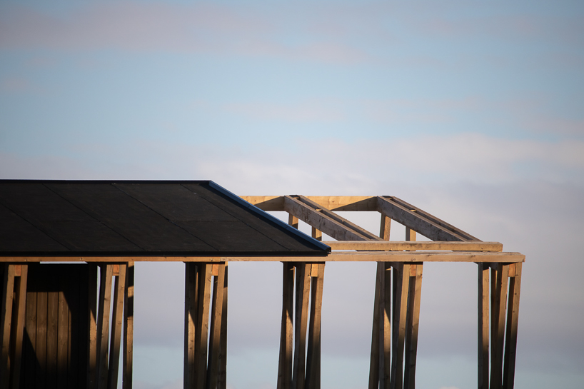 reclaimed timber frames shape skroget coastal sauna and community hub in norway - 5