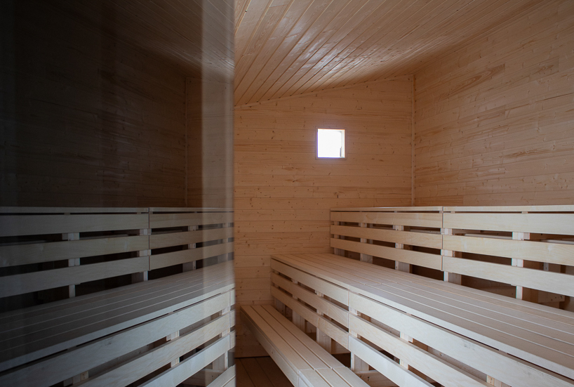 reclaimed timber frames shape skroget coastal sauna and community hub in norway - 9