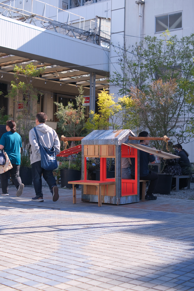portable barn serves as bench seating for pedestrians