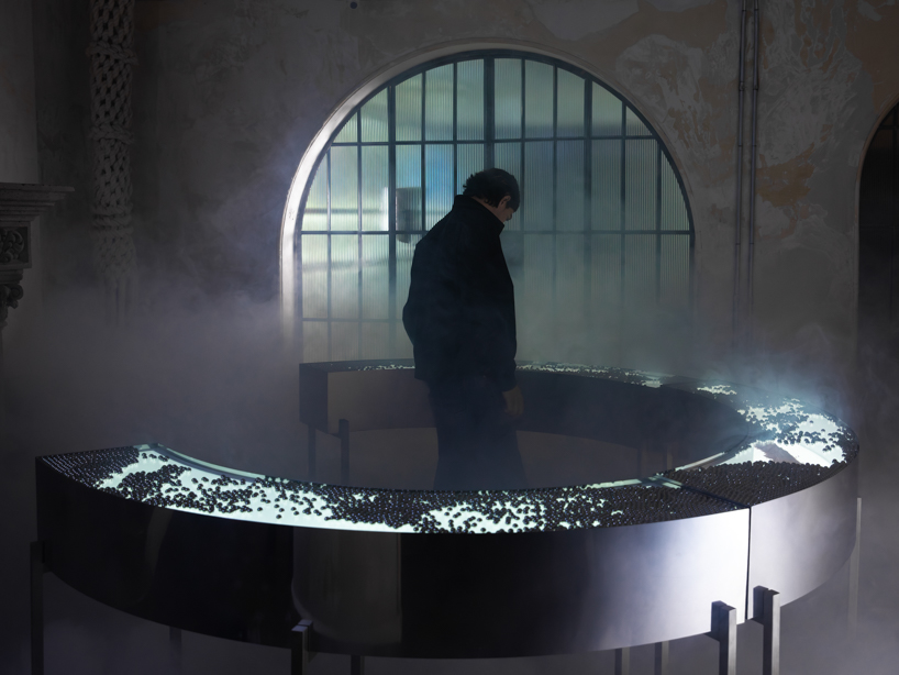 steel spheres moving across curved glass frame leonardo garza’s sensory installation for BYREDO - 7