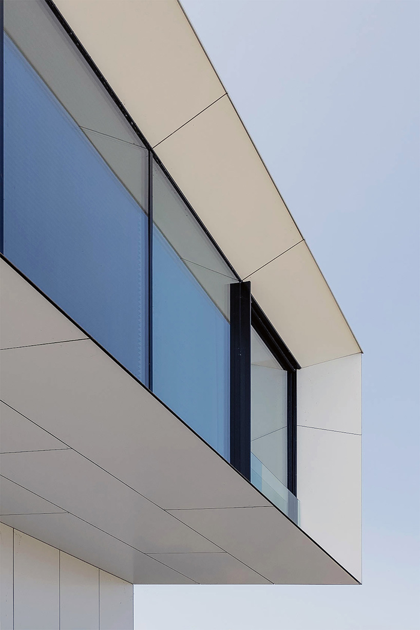 white aluminum cladding wraps tetris-like residence along lake in poland - 6