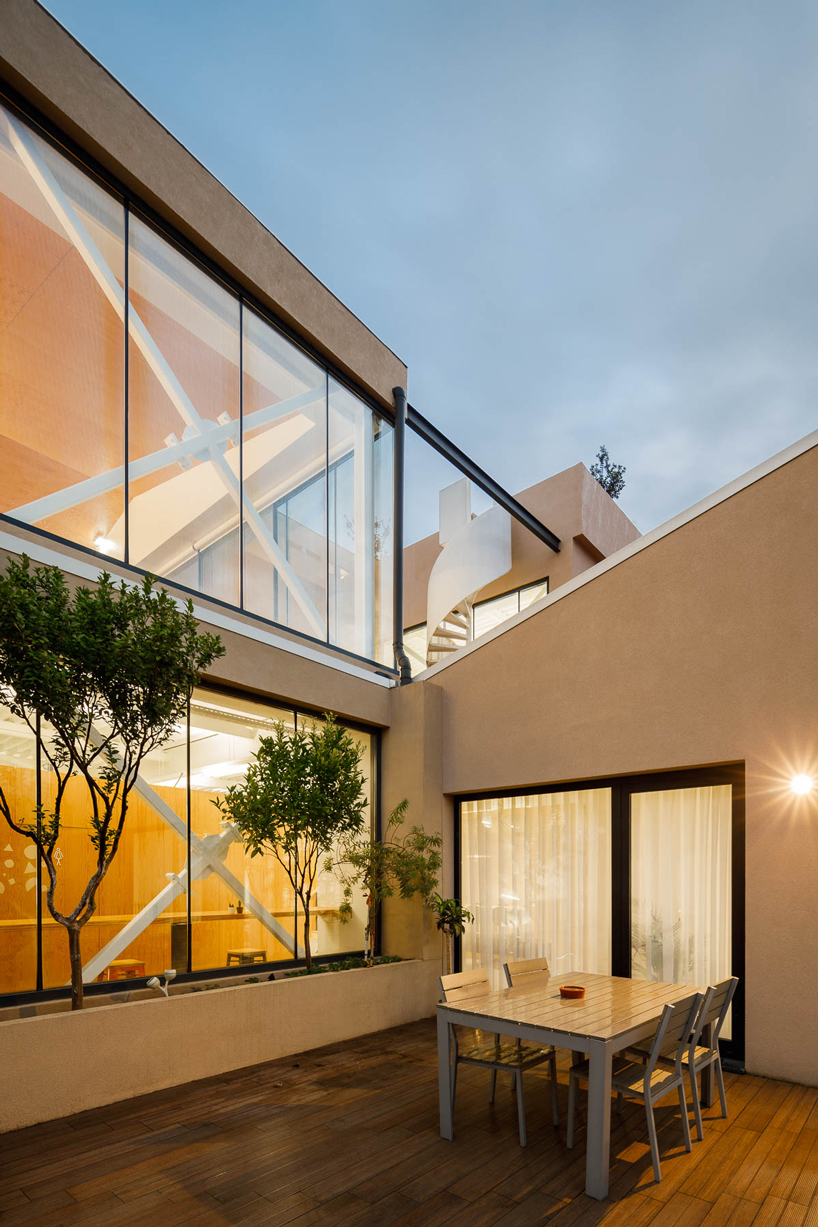 a spiral staircase connects paulo merlini's warehouse turned office in ...