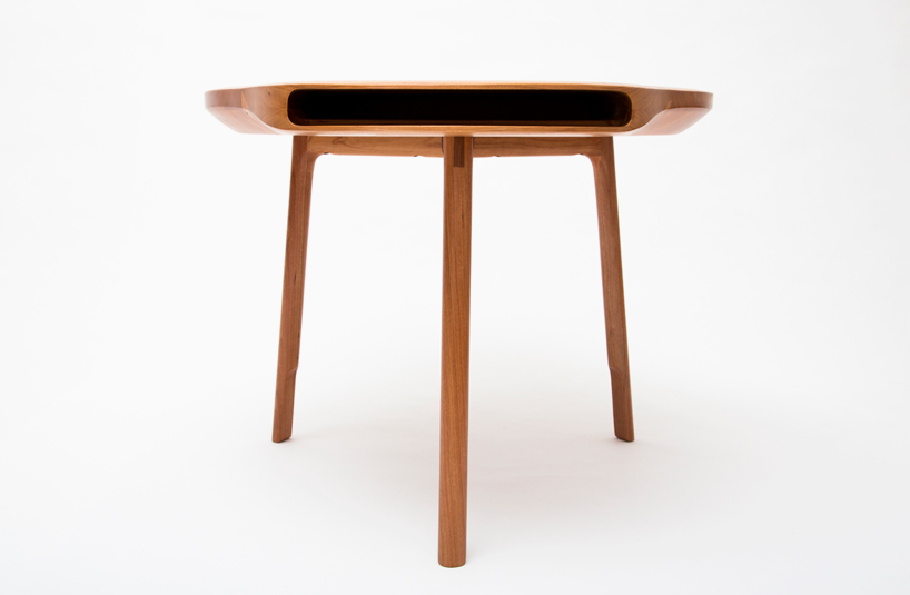 tokyo table by loic bard features discreet storage compartment