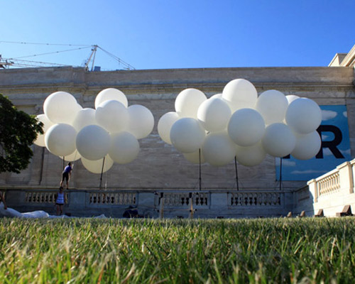 mark reigelman inflates white cloud with nearly 100 water balloons