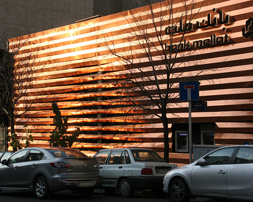 mellat bank commissions slatted copper façade from a trio of iranian architects