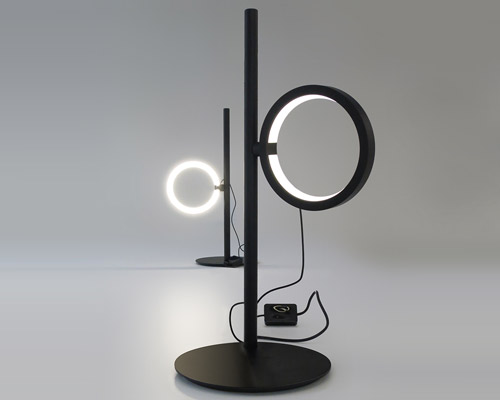 ipparco by neil poulton for artemide creates a rotating halo of light