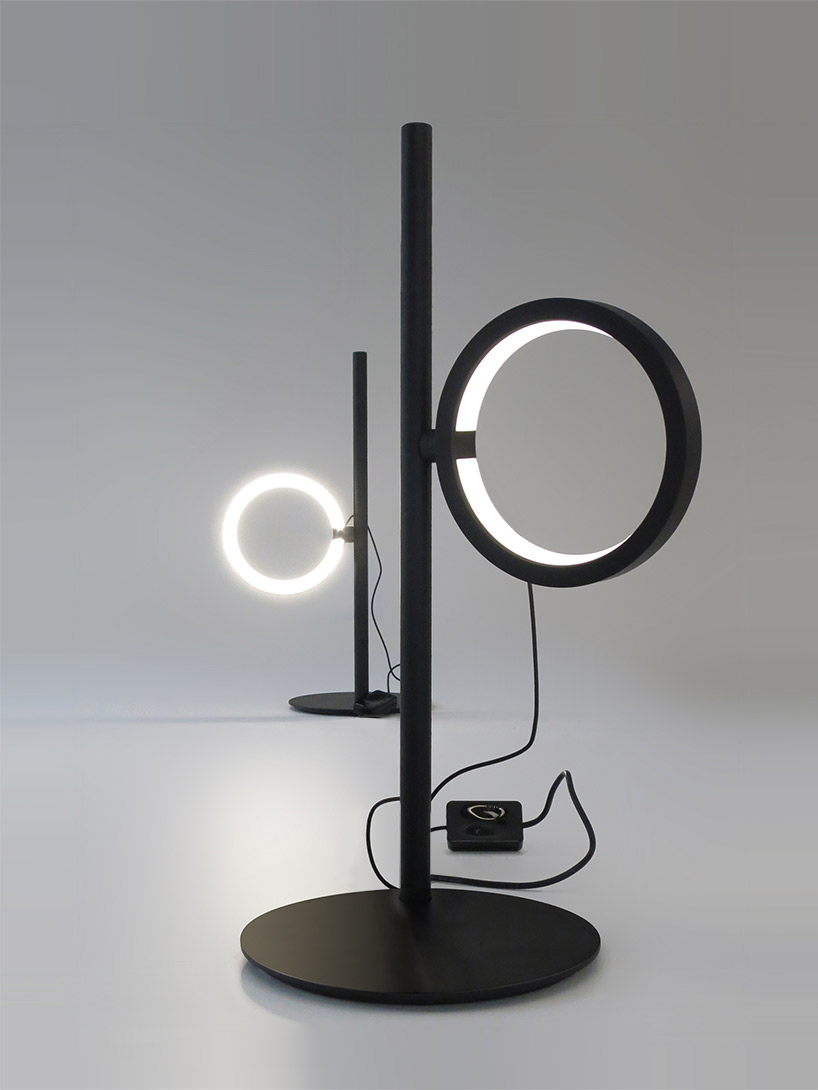 ipparco by neil poulton for artemide creates a rotating halo of light