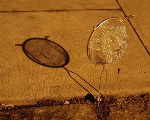 isaac cordal casts shadows with strainer faces