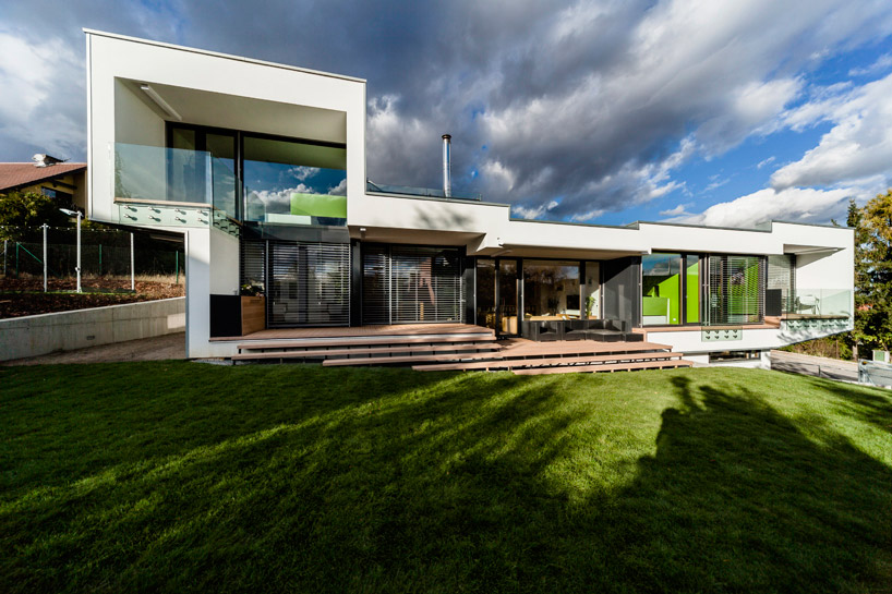 sloped semi cantilever house by grido architektura