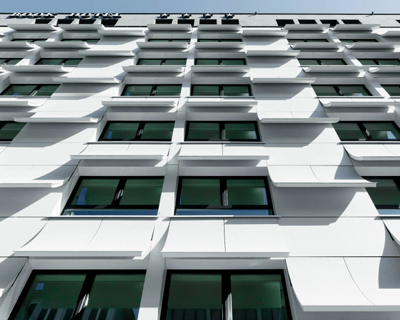 book pages transformed into a concrete hotel facade in munich