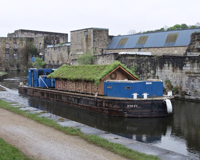 the ark   a wooden house floating on a boat by beth derbyshire